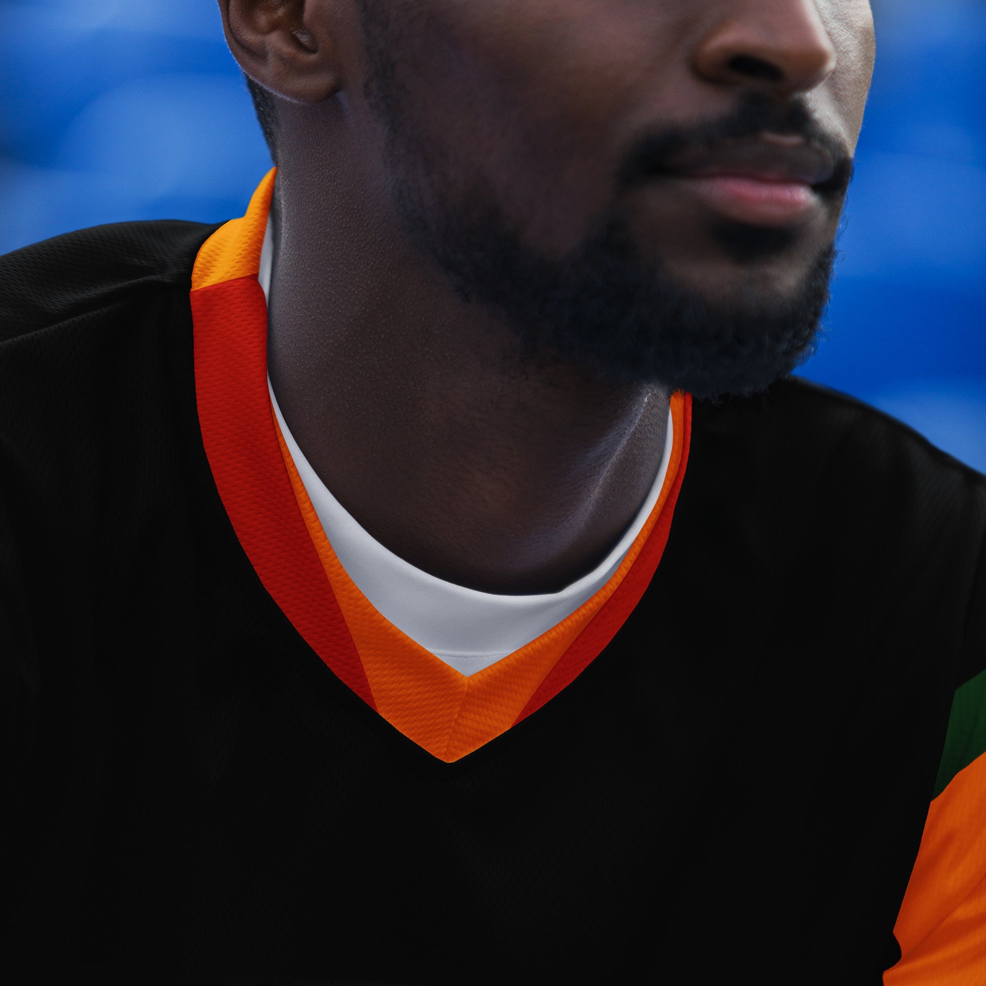 - “Afro-Caribbean jersey with red, gold, and green Rasta colors and number 19 design”